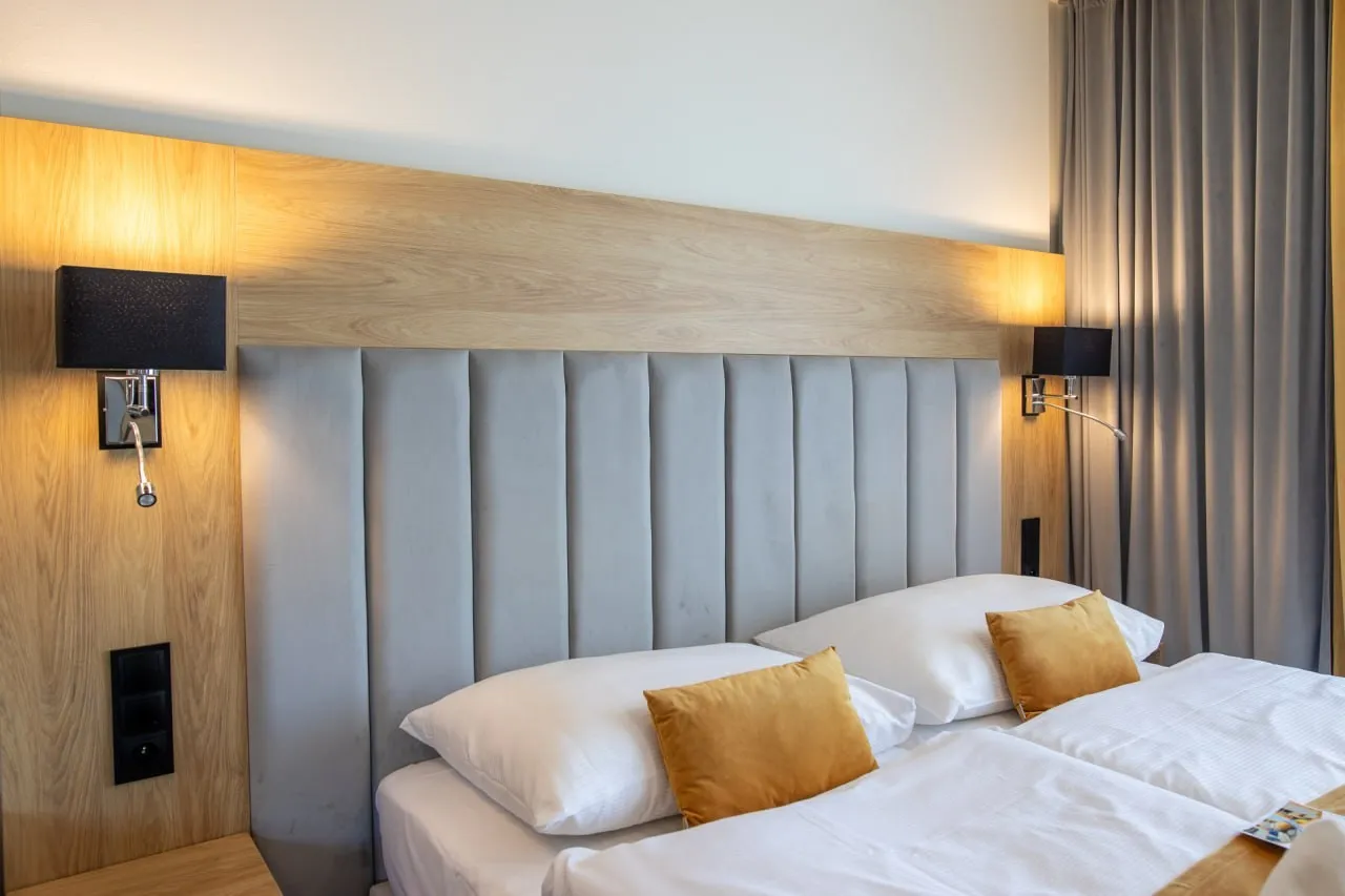Bed runner and decorative cushions in a hotel room