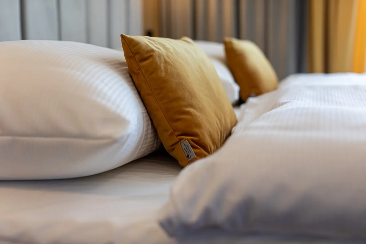 Decorative cushions and hotel bed linen up close