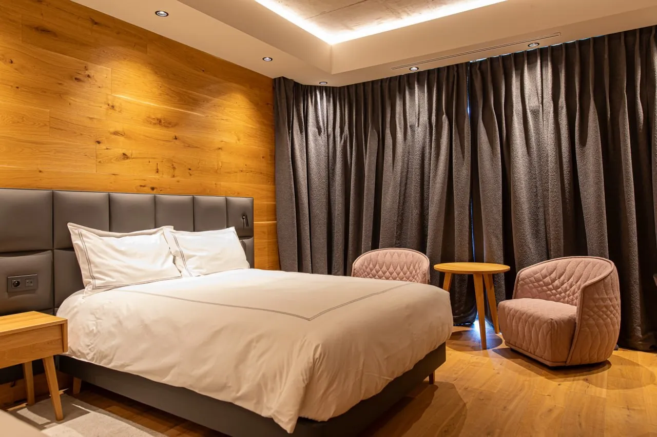 Curtains and bed runners in a suite at Swissôtel Damian Jasná