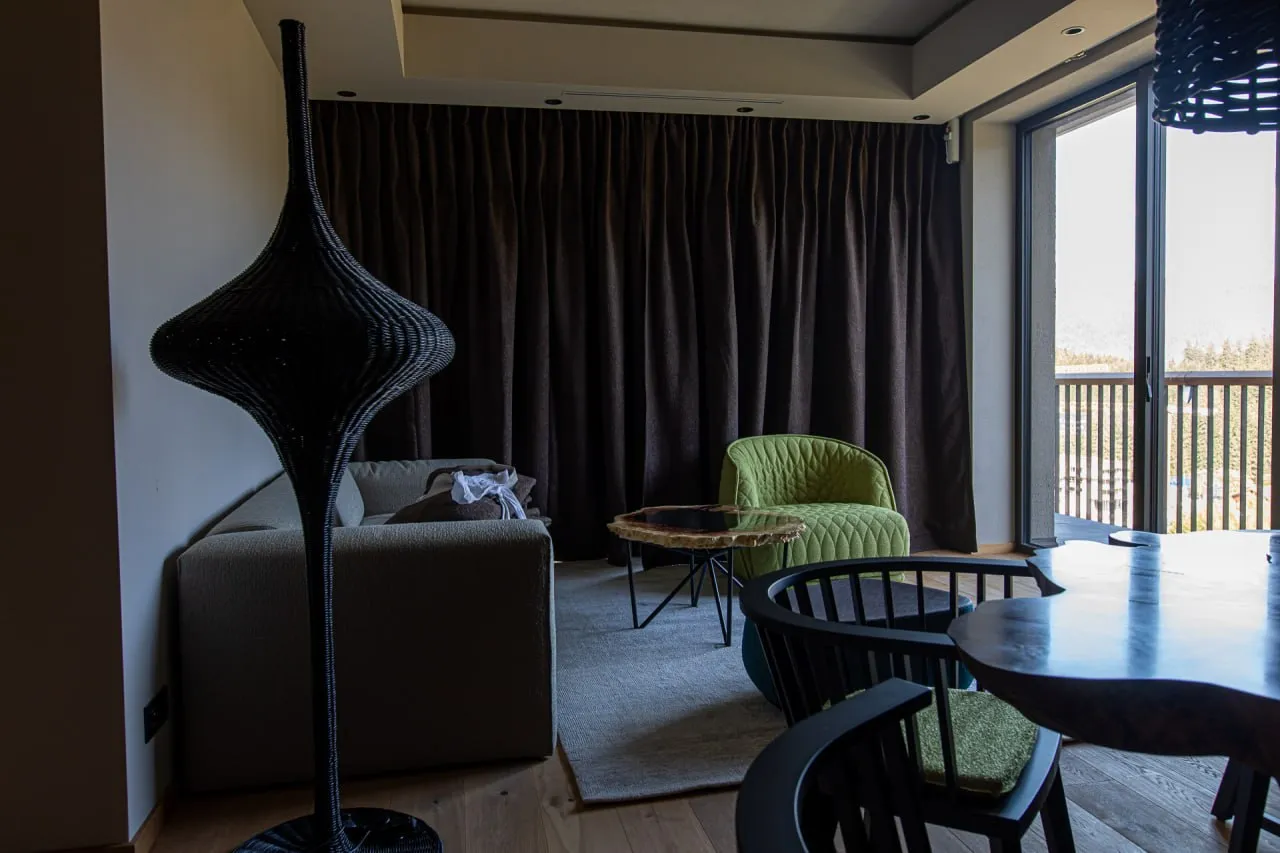 The living area of a suite with its full textile set