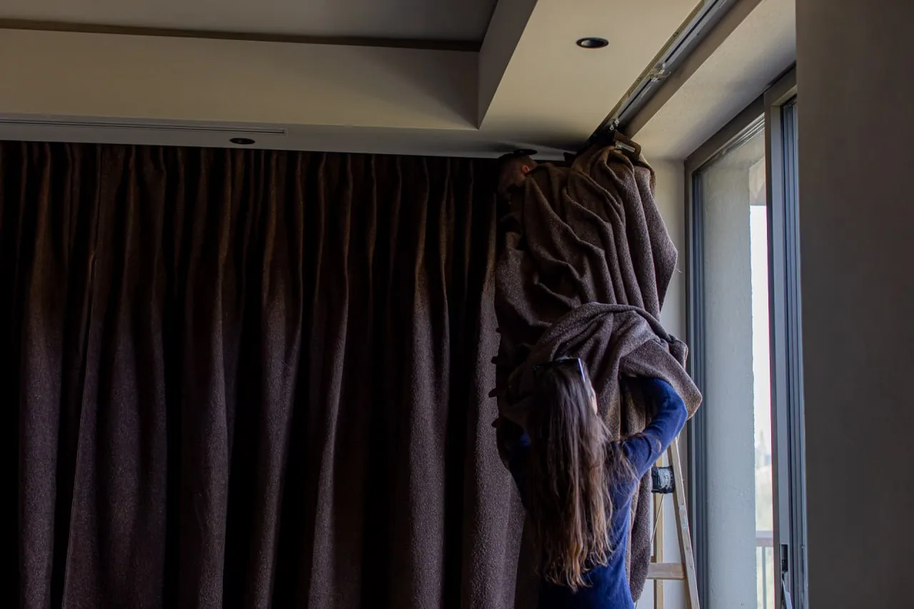 Our team hanging curtains in a suite